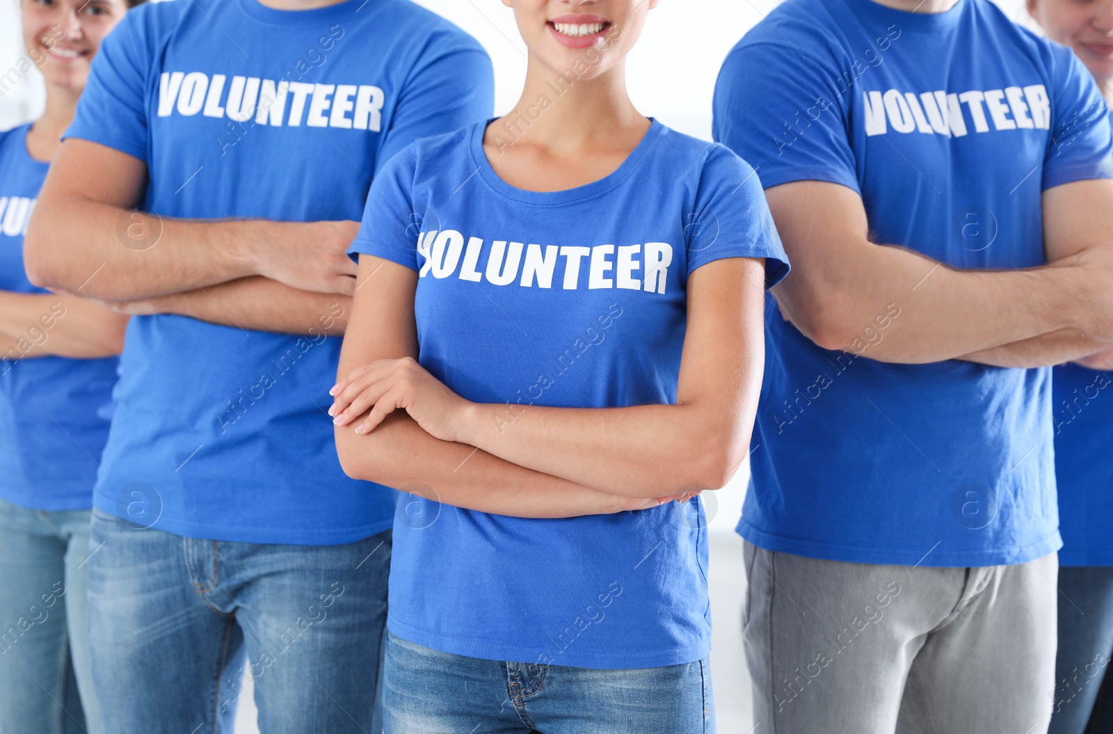 Photo of Team of young volunteers on light background. Collecting donations