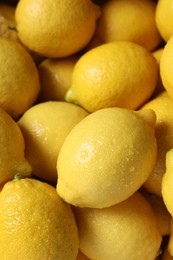 Photo of Fresh lemons with water drops as background, closeup