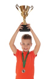 Photo of Happy boy with golden winning cup and medal isolated on white