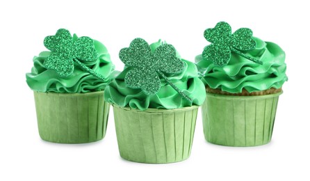 Photo of St. Patrick's day party. Tasty cupcakes with green clover leaf toppers and cream isolated on white