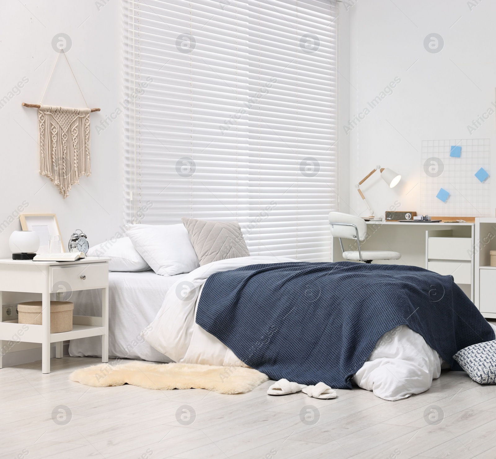 Photo of Bedroom interior with comfortable furniture, big window and white blinds