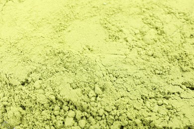 Photo of Green matcha powder as background, closeup view