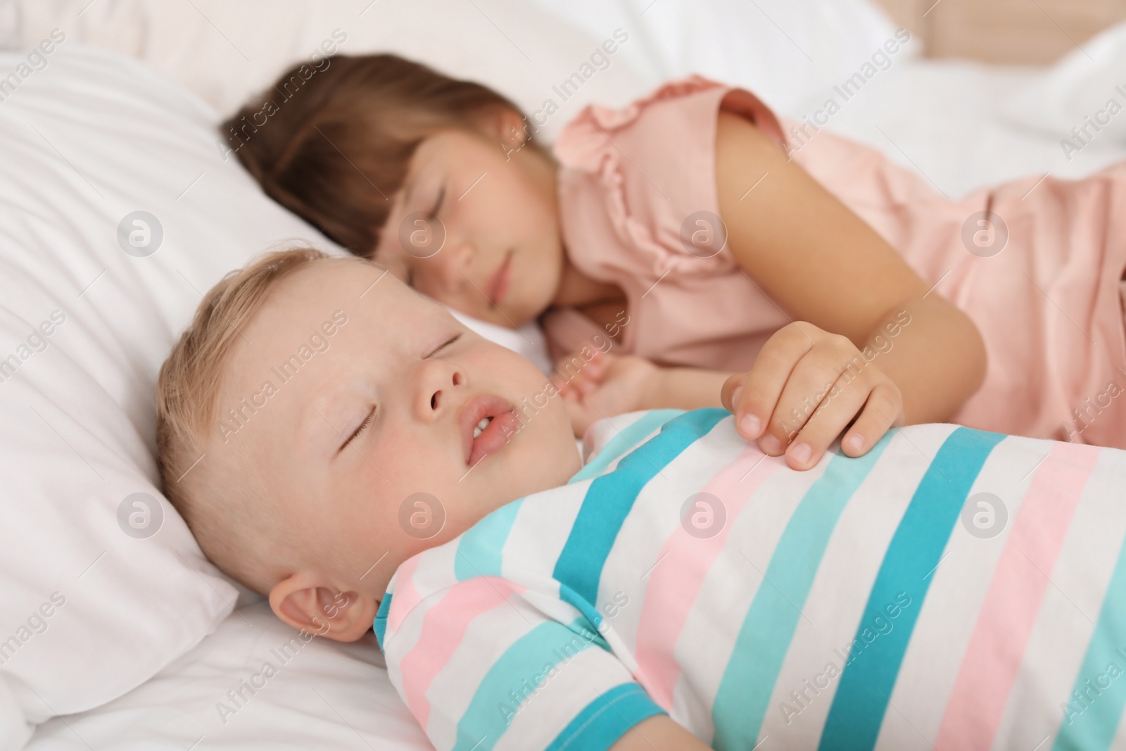 Photo of Little children sleeping in bed at home