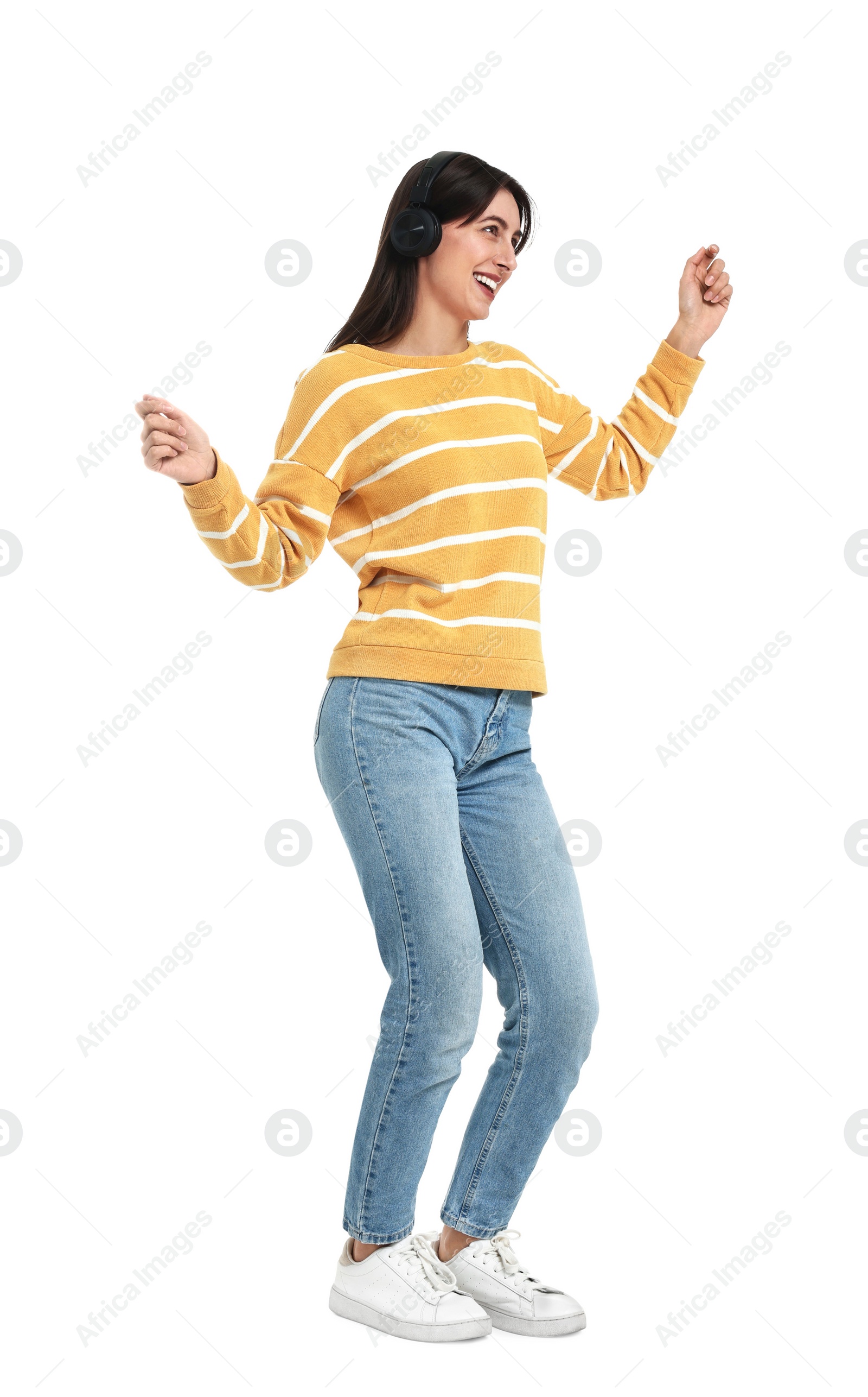 Photo of Happy woman with headphones dancing on white background