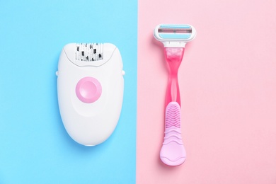 Modern epilator and razor on color background