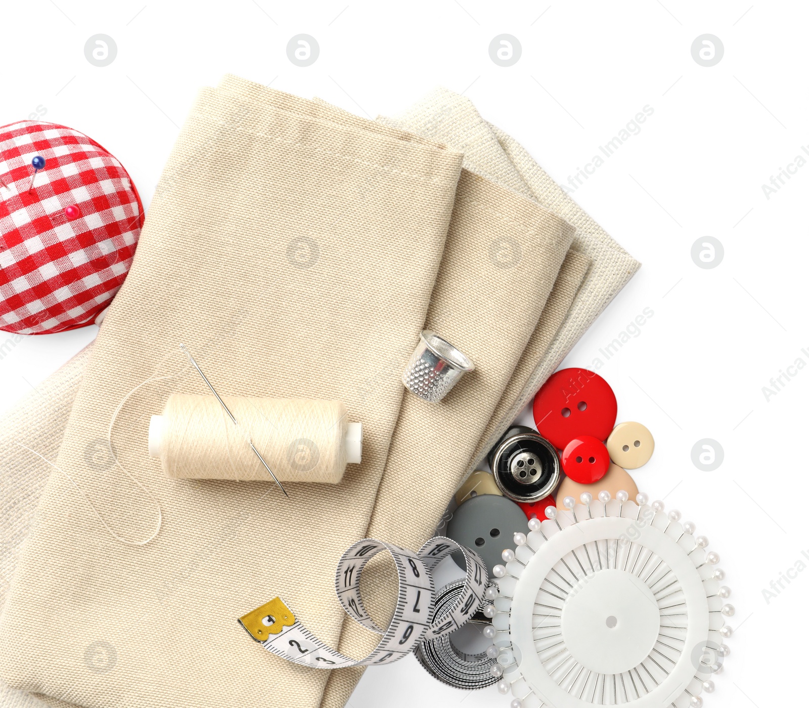 Photo of Spool of thread and sewing tools on white background, top view