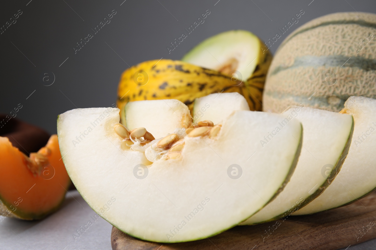 Photo of Tasty colorful ripe melons on table, closeup