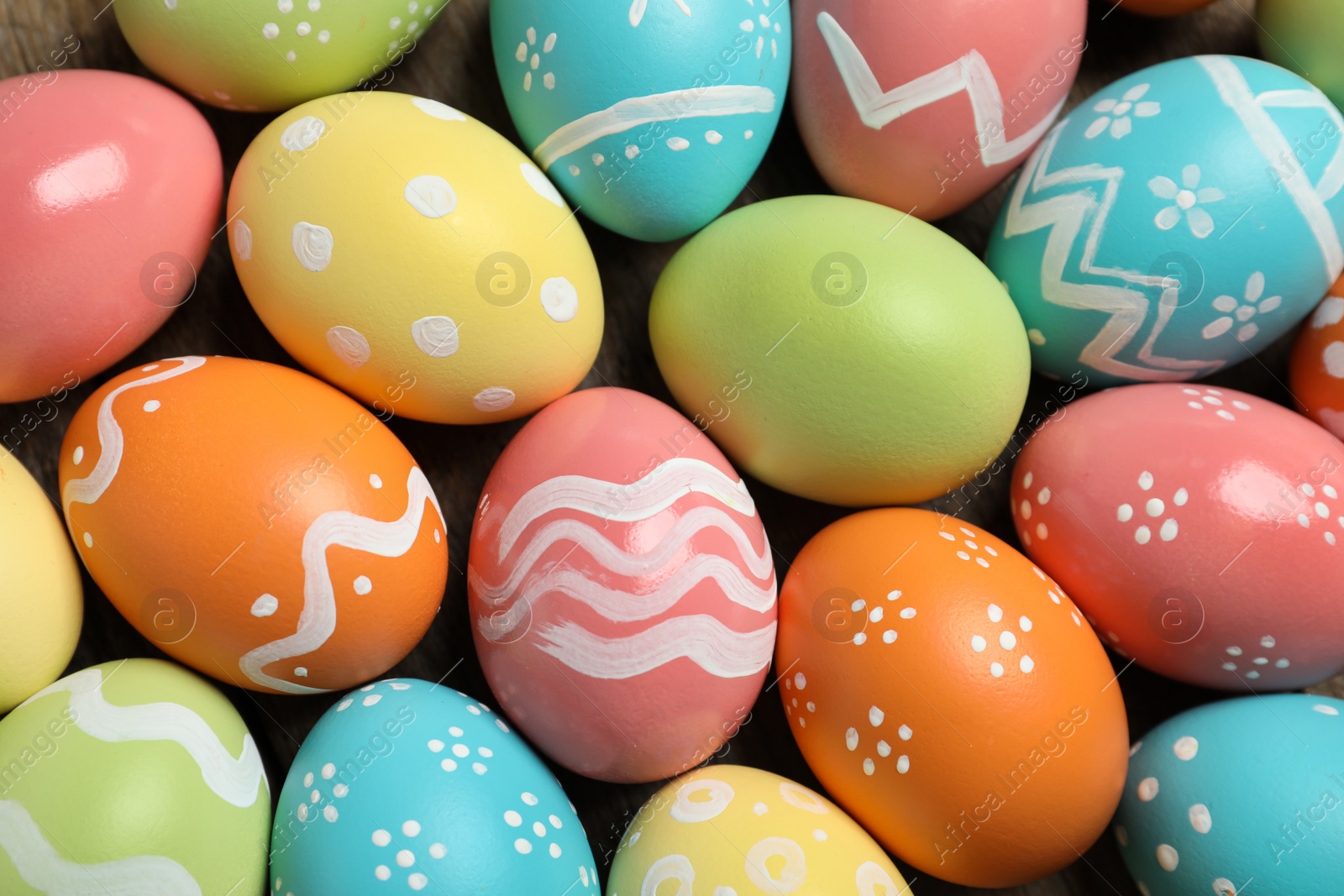 Photo of Many colorful painted Easter eggs as background, closeup