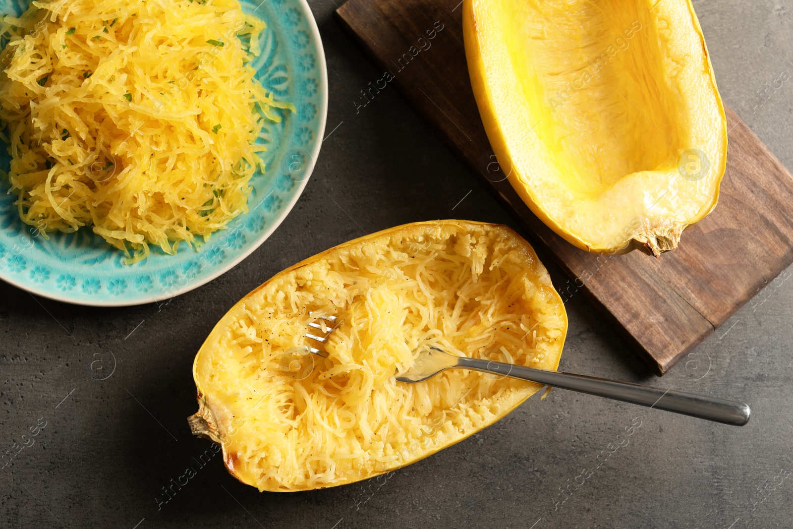 Photo of Flat lay composition with cooked spaghetti squash and fork on gray background