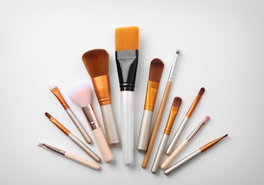 Photo of Makeup brushes of professional artist on white background