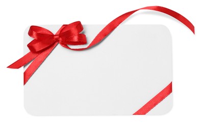 Photo of Blank gift card with red bow isolated on white, top view