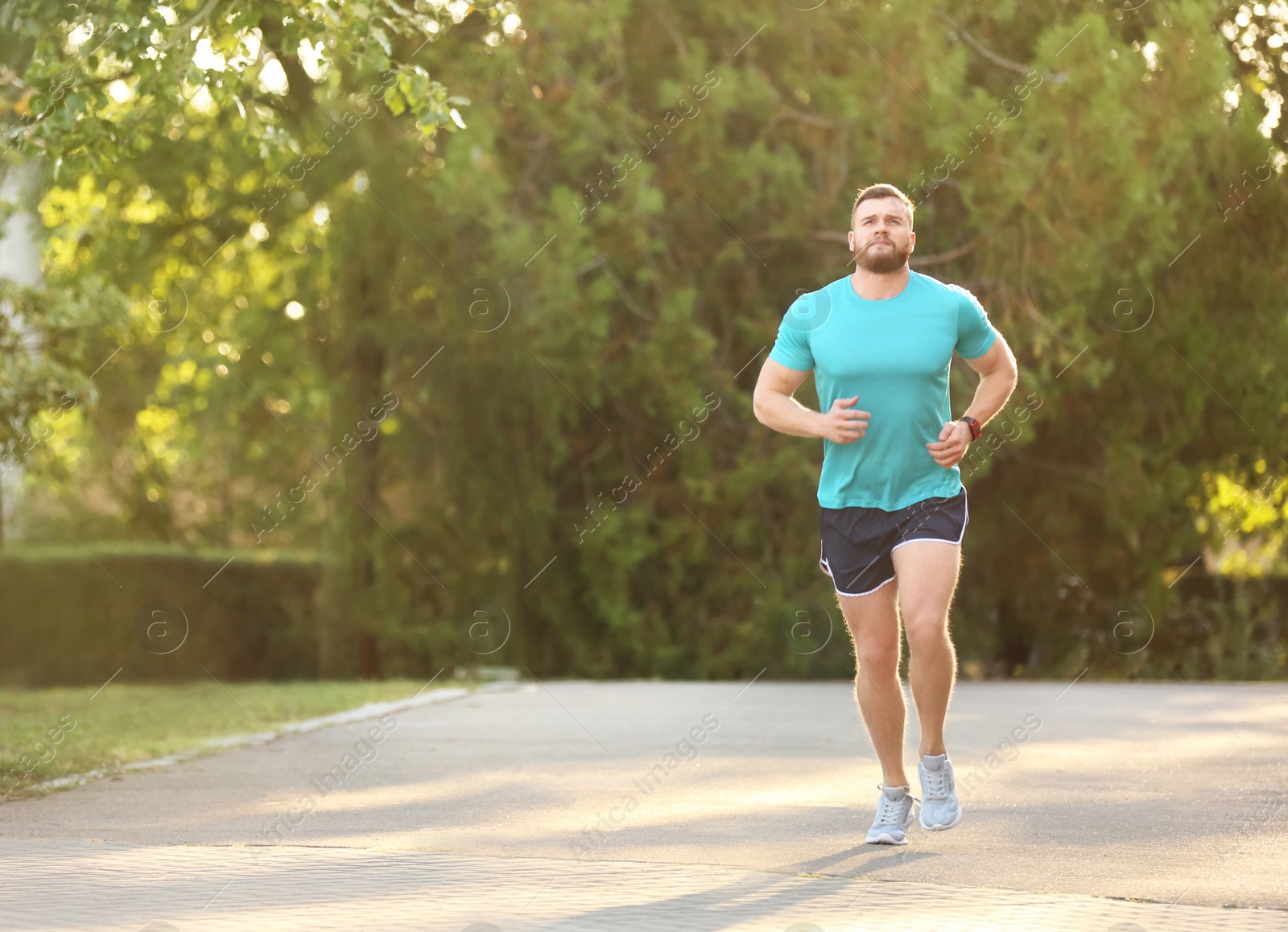 Photo of Young man running in park on sunny day