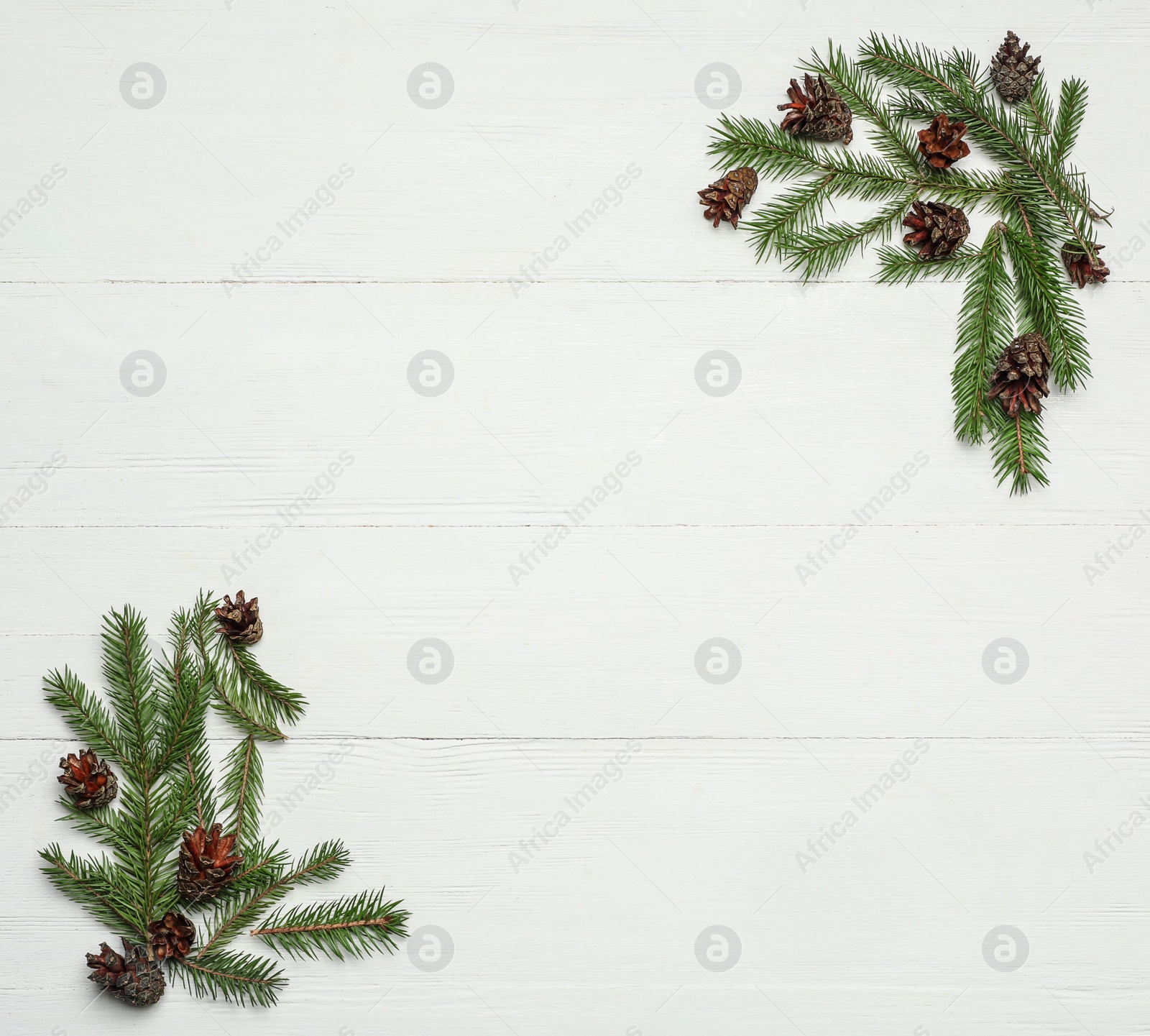 Photo of Flat lay composition with pinecones on white wooden background, space for text