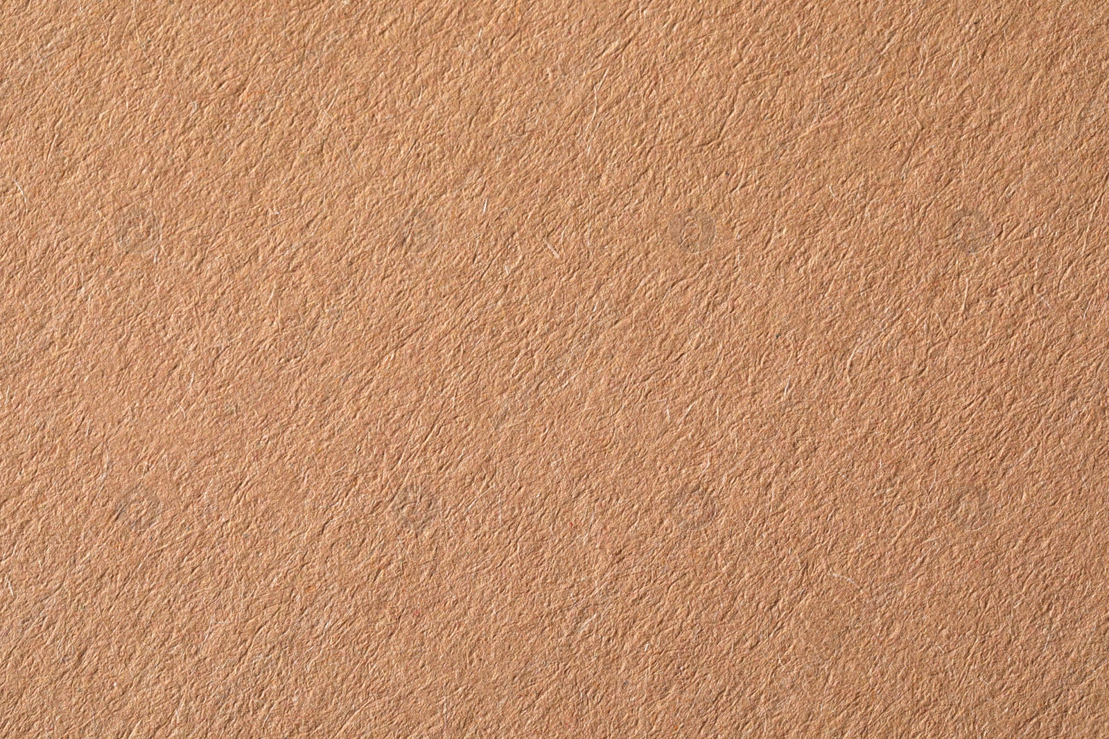 Photo of Texture of kraft paper sheet as background, closeup