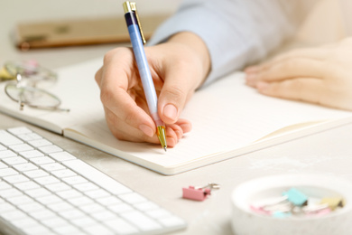 Image of Journalist working at table in office, closeup