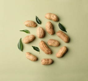 Photo of Composition with peanuts on color background, top view