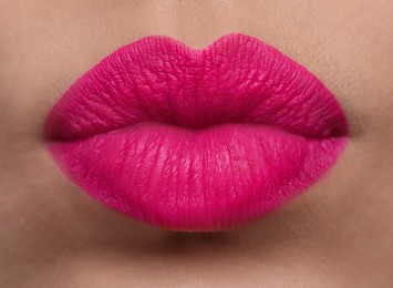 Photo of Closeup view of beautiful woman puckering lips for kiss