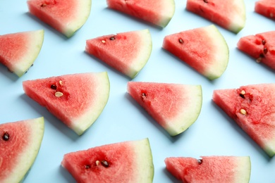 Photo of Slices of ripe watermelon on light blue background