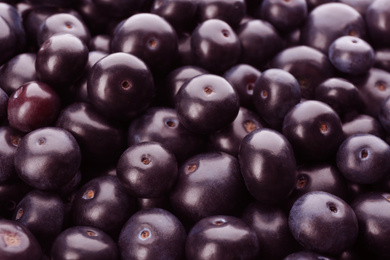 Photo of Fresh ripe acai berries as background, closeup