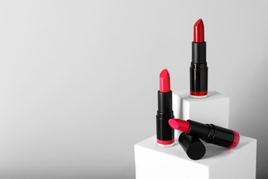 Photo of Different beautiful lipsticks on light gray background, space for text
