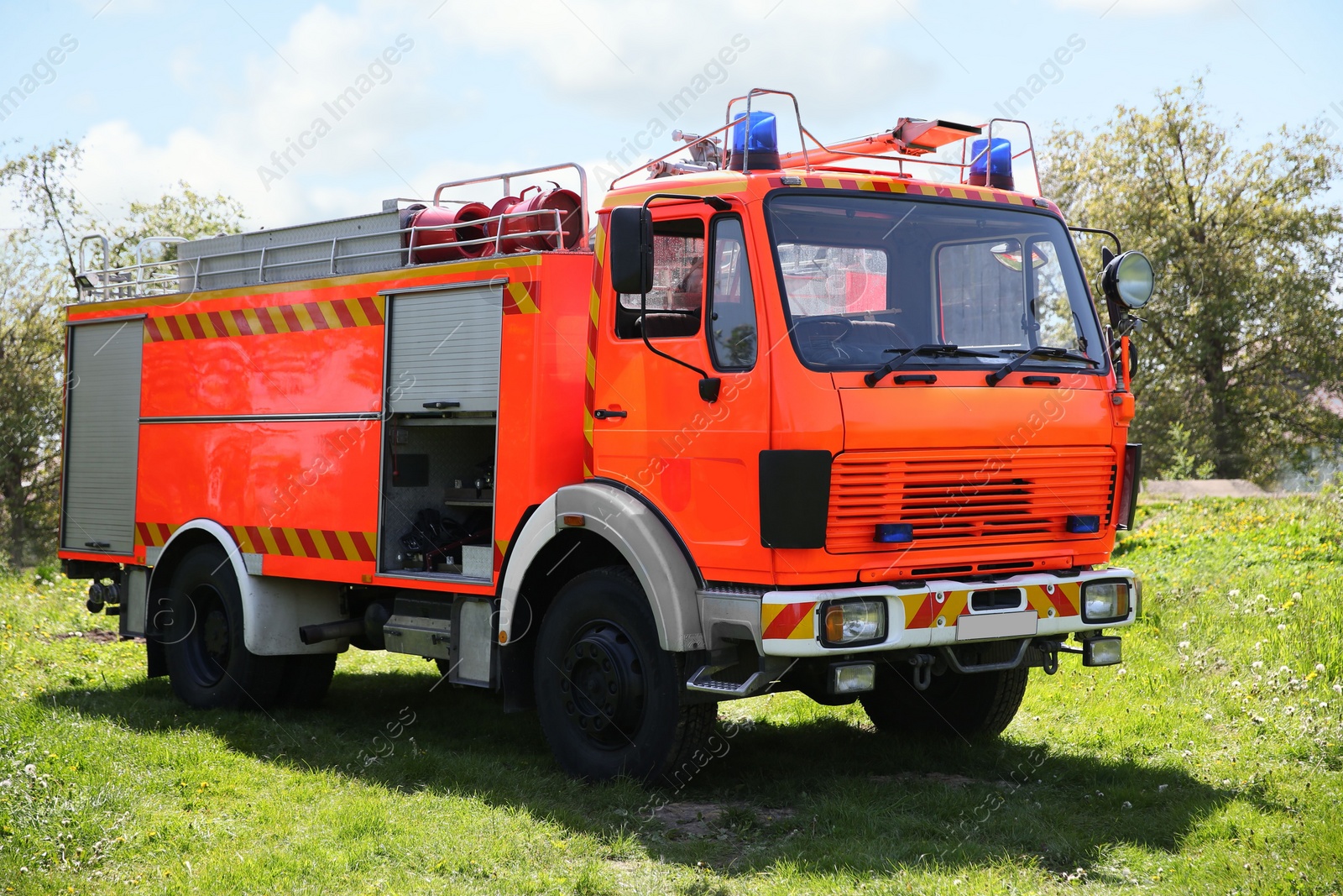 Photo of One modern orange fire truck on sunny day