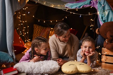 Photo of Mother and her children in play tent at home