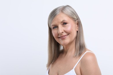 Portrait of beautiful senior woman on white background. Space for text
