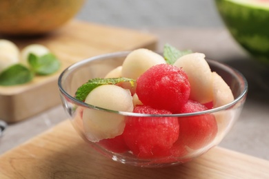 Bowl with melon and watermelon balls on table