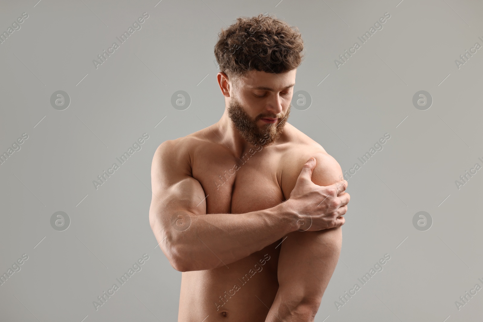 Photo of Handsome man with muscular body on light grey background