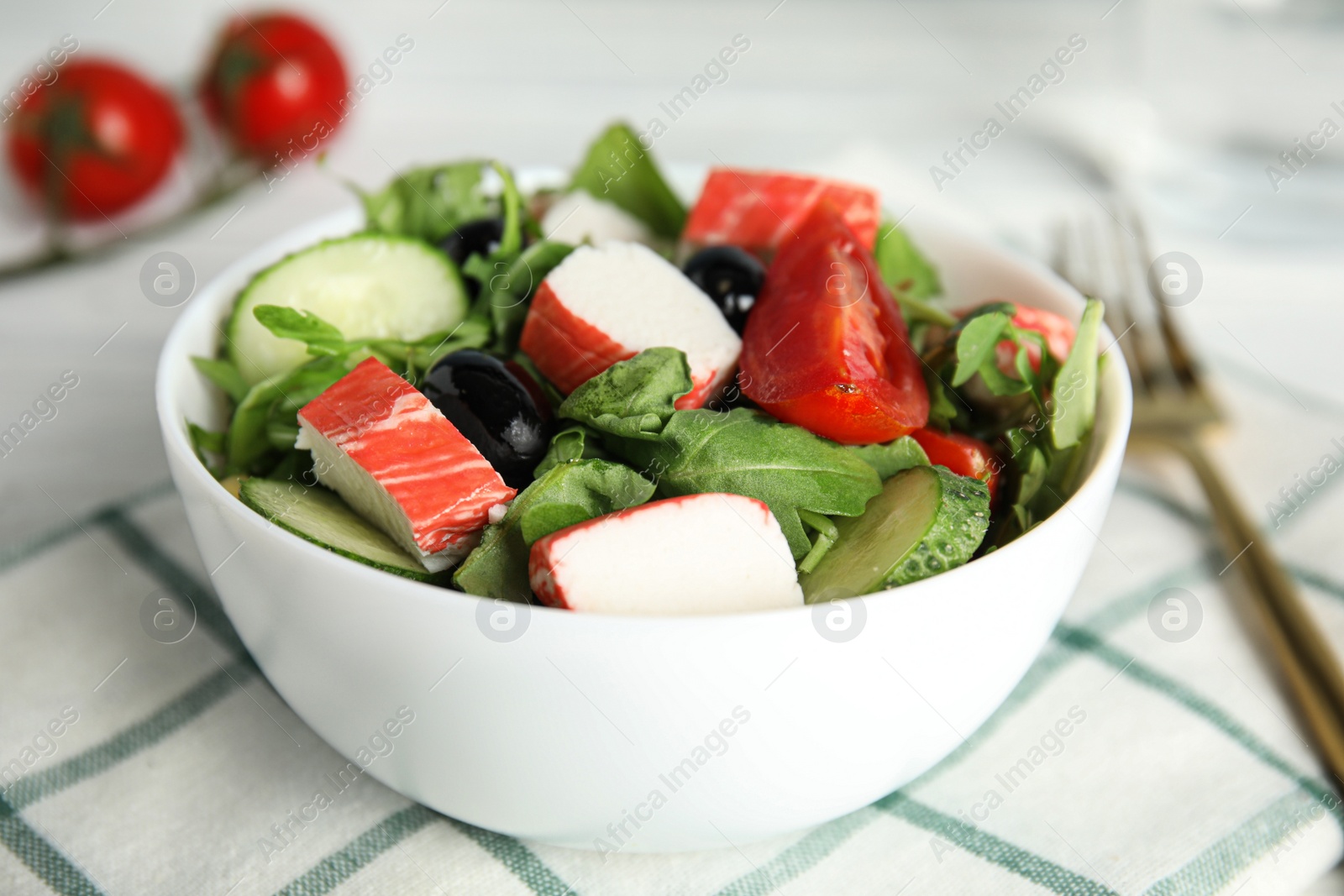 Photo of Tasty crab stick salad served on table, closeup