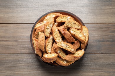 Photo of Traditional Italian almond biscuits (Cantucci) on wooden table, top view
