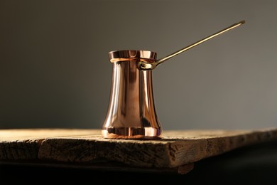 Beautiful copper turkish coffee pot on wooden table