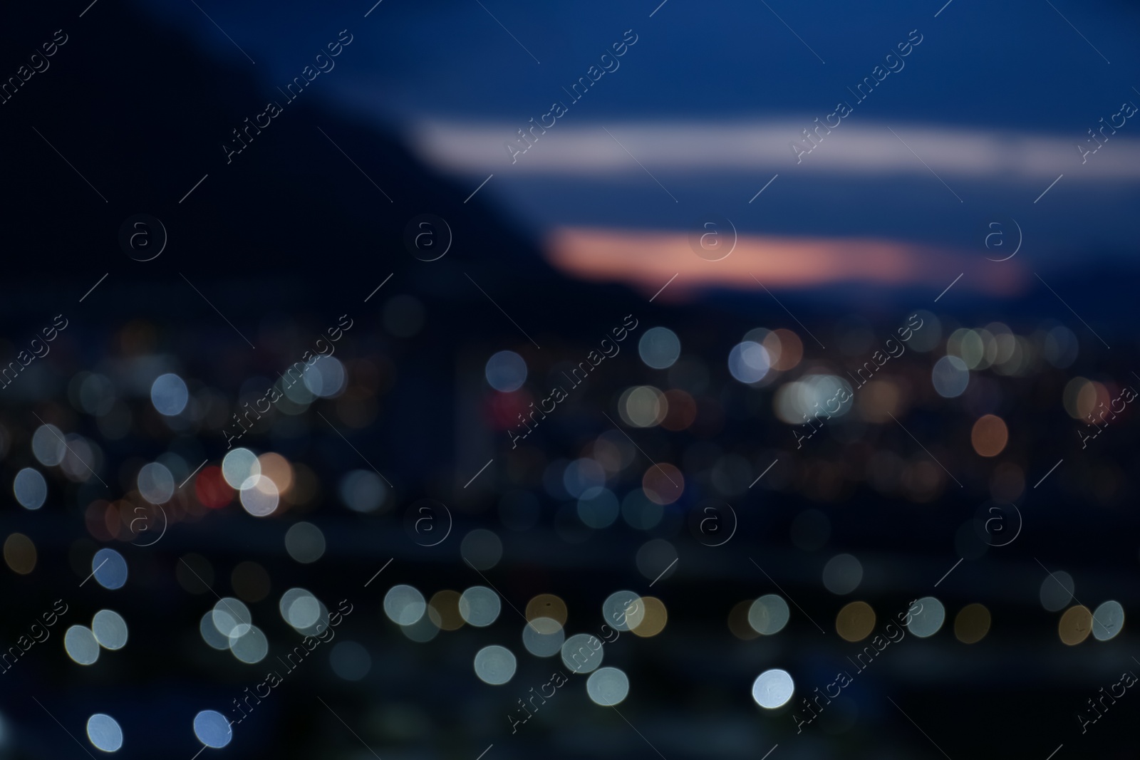 Photo of Blurred view of cityscape and mountains, bokeh effect