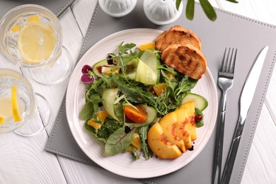 Photo of Delicious salad with fruits and vegetables served on white wooden table, flat lay