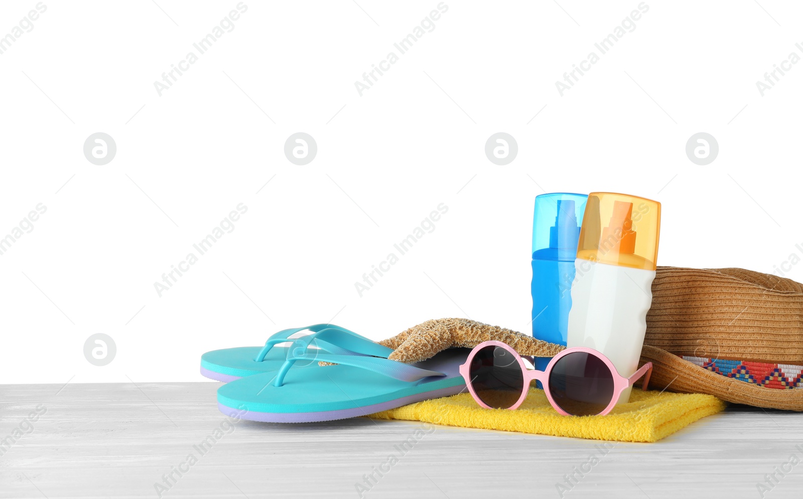 Photo of Set of beach accessories on table against white background. Space for text