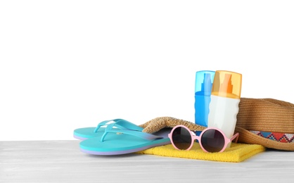 Set of beach accessories on table against white background. Space for text