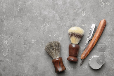 Photo of Flat lay composition with men's shaving accessories and space for text on gray background