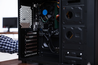 Opened system unit on table, closeup. Computer repair