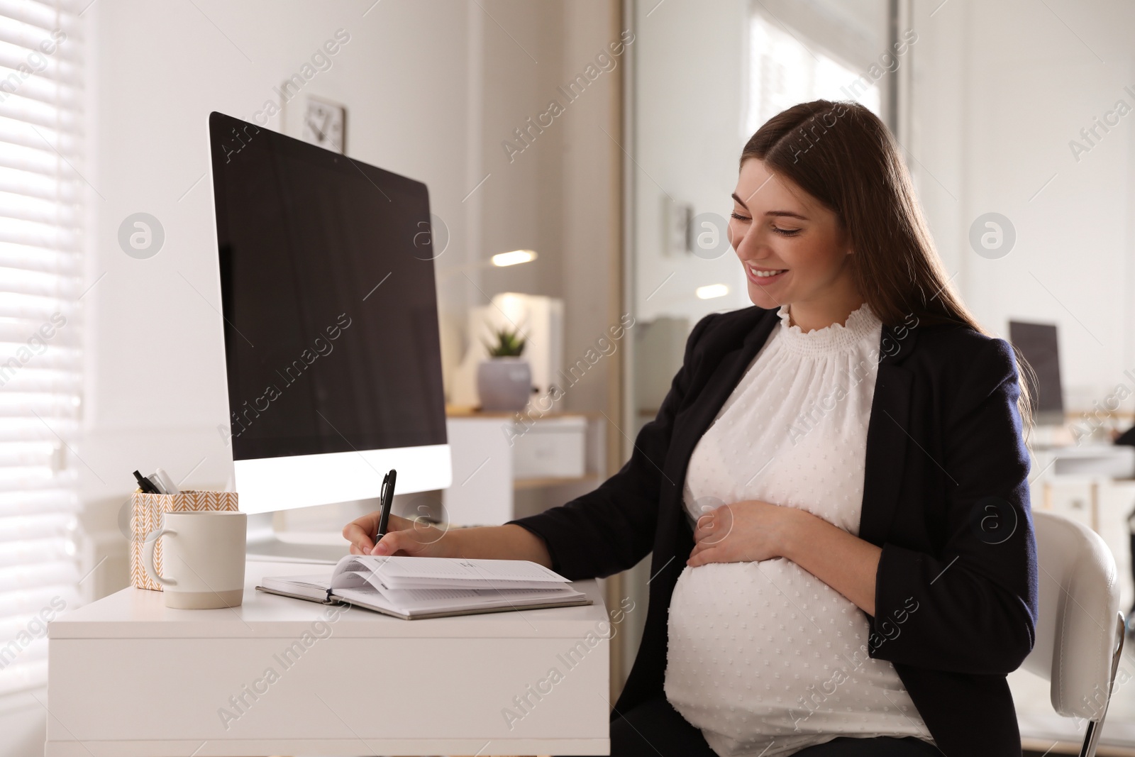 Photo of Pregnant woman working at home. Maternity leave