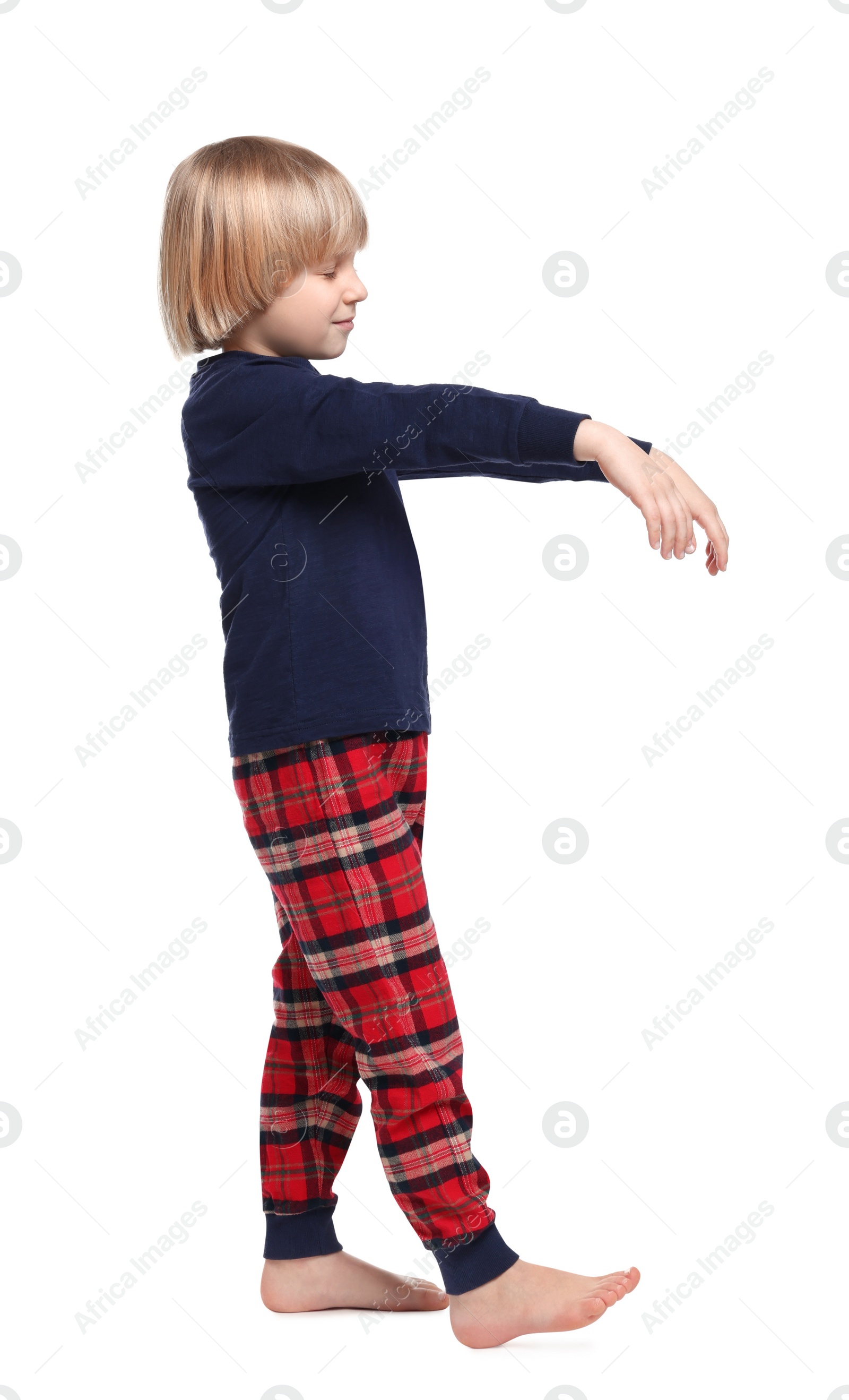 Photo of Boy in pajamas sleepwalking on white background