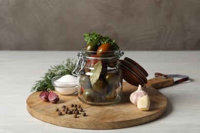Photo of Pickling jar with fresh ripe tomatoes on white table