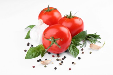 Photo of Ripe tomatoes, garlic, herbs and spices on white background, closeup