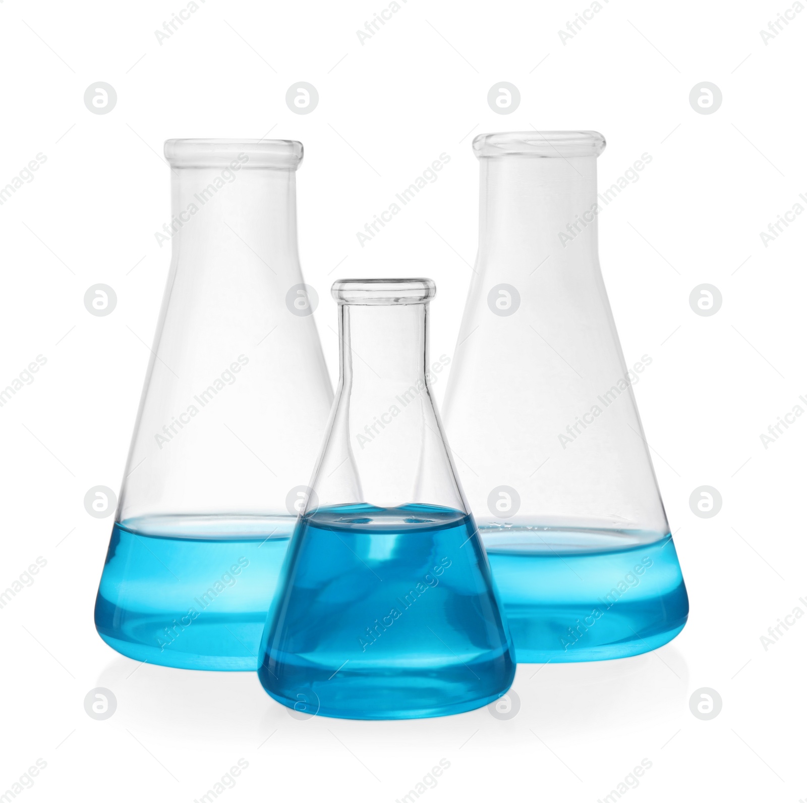 Photo of Different laboratory glassware with light blue liquid on white background