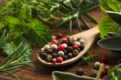 Different fresh herbs and spices on wooden table, closeup