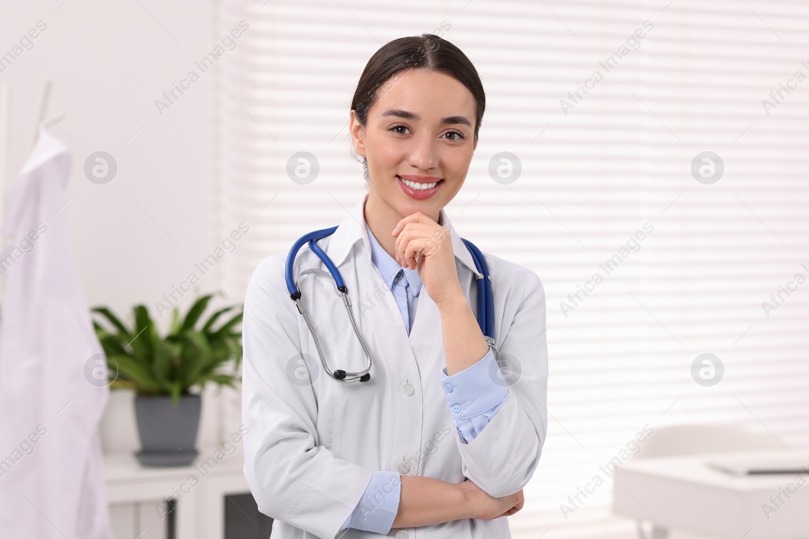 Photo of Portrait of medical consultant with stethoscope in clinic