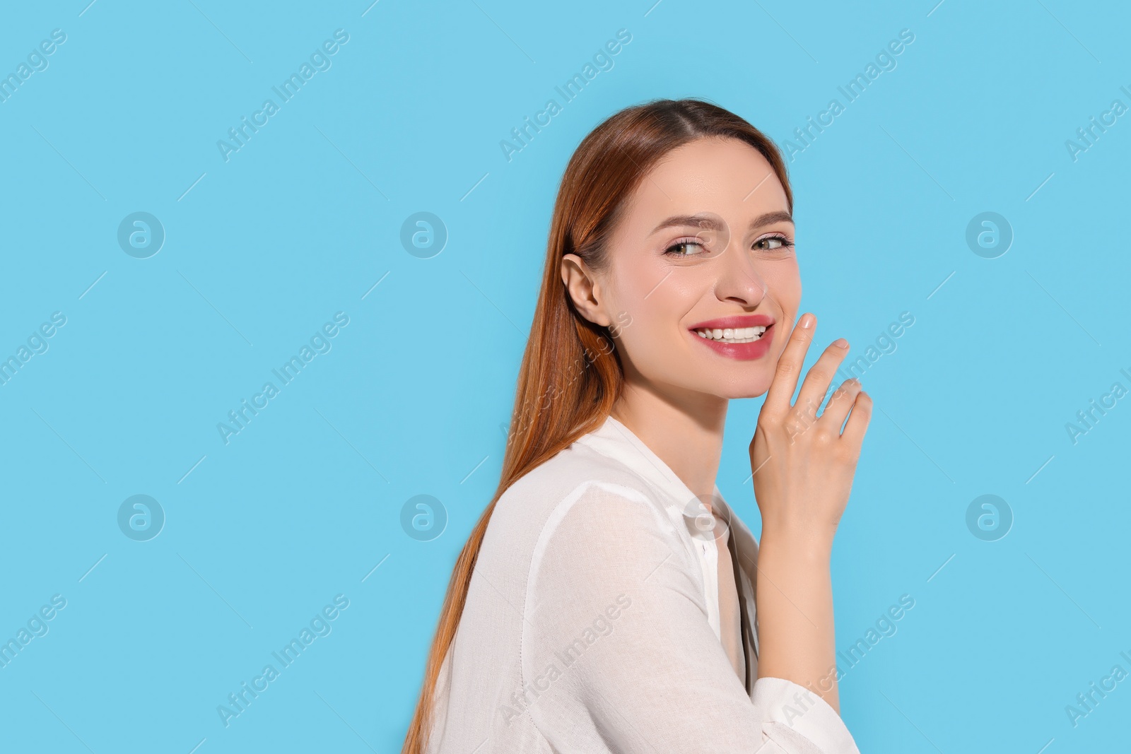 Photo of Beautiful young woman on light blue background, space for text