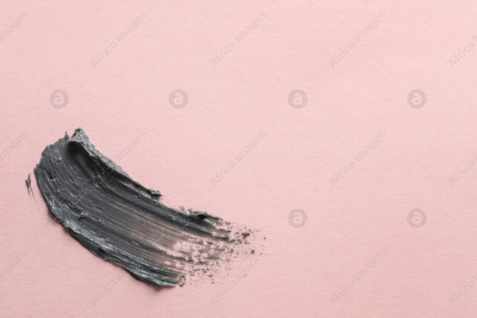 Photo of Sample of face mask on pink background, top view. Space for text