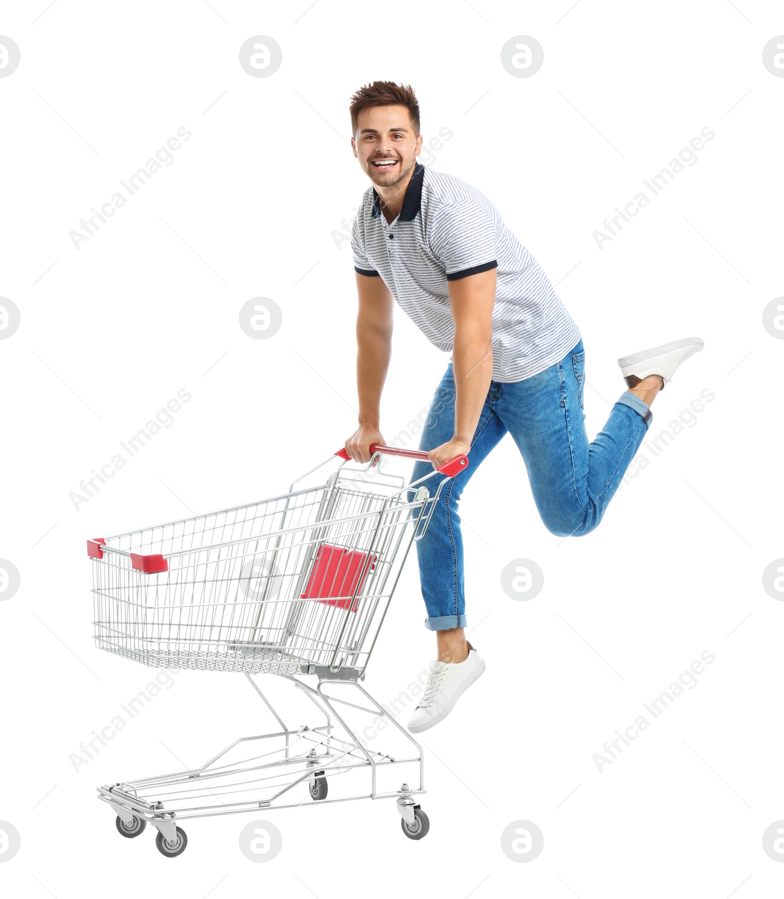 Photo of Young man with empty shopping cart on white background