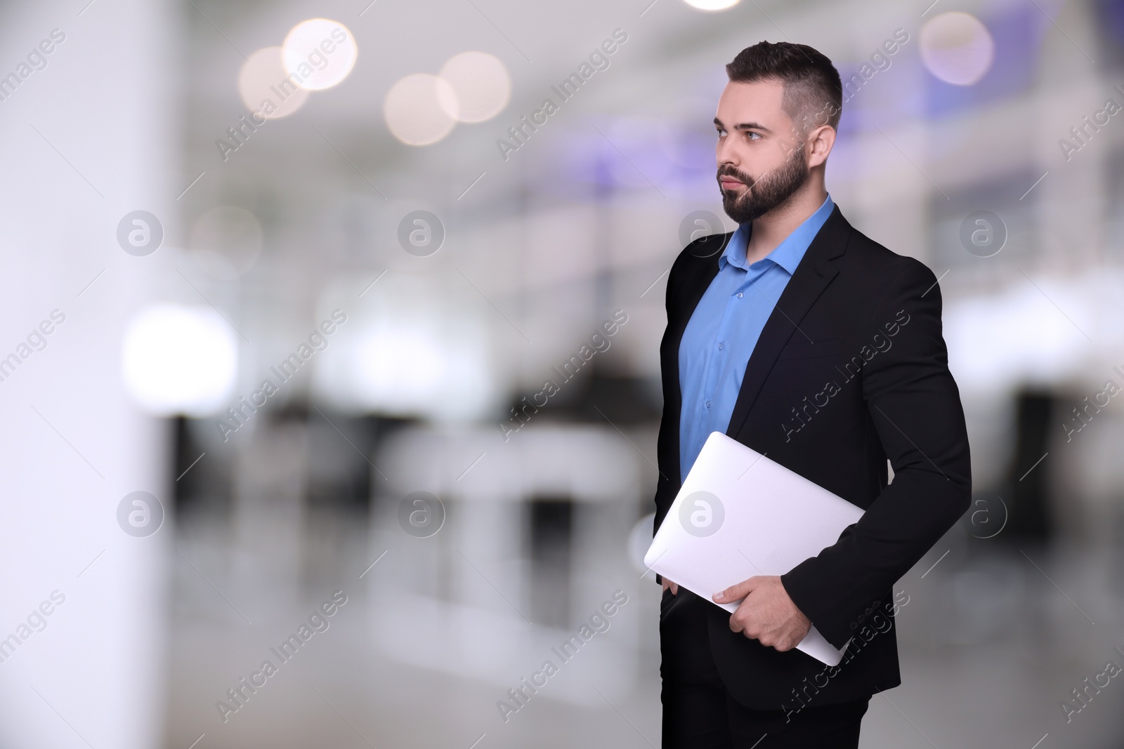 Image of Successful lawyer with laptop on blurred background, space for text