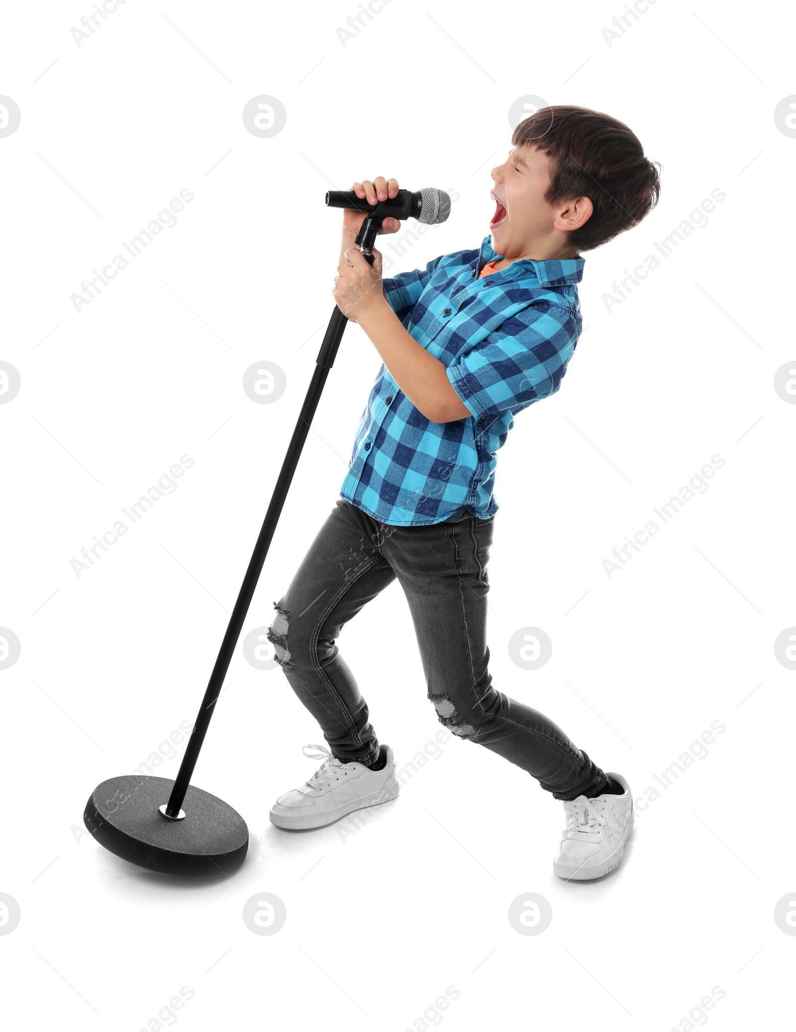 Photo of Cute little boy singing into microphone on white background